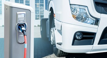 America’s Going Electric Electric vehicles charging station on a background of a truck. Concept