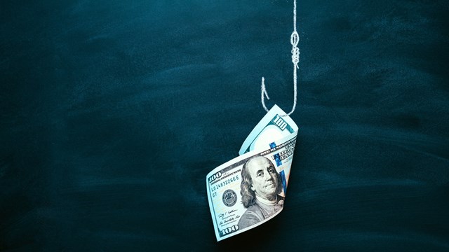 US 100 dollar bill as a bait. American currency on the hook. Investment risk or money trap, business fraud and cheating or financial pitfall and mistake concept. Copy space