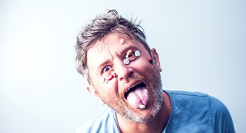 Q&A: Disturbing Neighbors Funny man with a lot of different pills on his face. Medicine concept