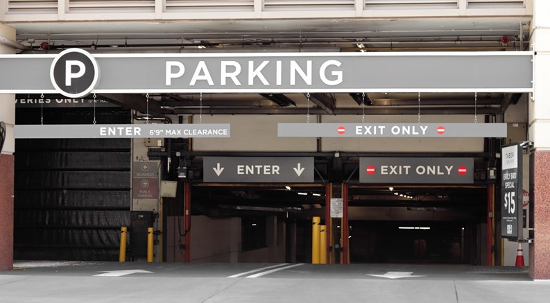 Parking sign in front of a parking garage downtown