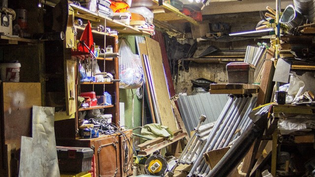 Big mess in an over stuffed suburban garage.