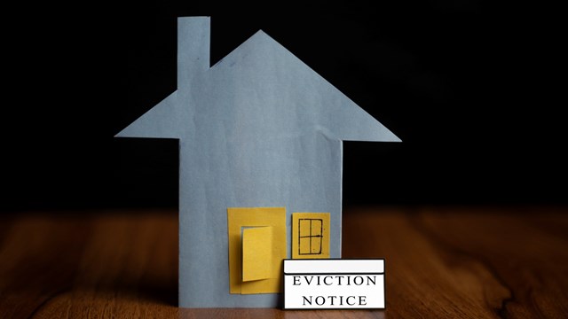 eviction notice sticker IN front of door - concept showing of tenant foreclosure or rent pending on black background