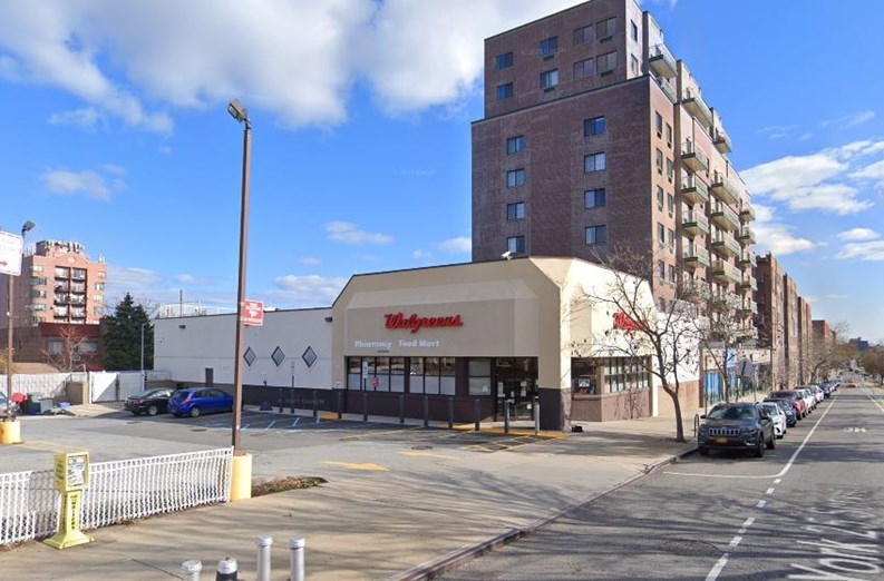 A parking lot, Walgreens pharmacy store, and mid-rise apartment building in Woodside, Queens, New York