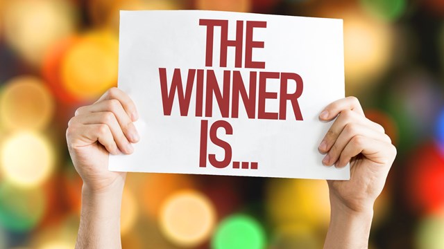 The Winner Is... placard with bokeh background