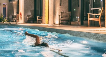 Using Your Amenities to Generate Cash Flow Swimmer exercising in a condo's indoor pool