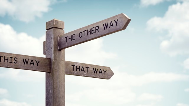 Crossroad signpost saying this way, that way, the other way concept for lost, confusion or decisions