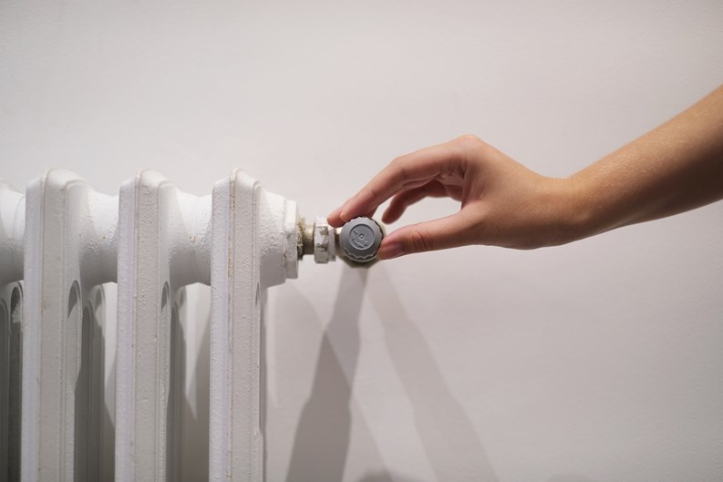 white radiator on a light wall in the room