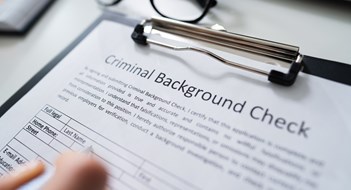 Q&A: Investigating Residents Close-up Of Human Hand Filling Criminal Background Check Application Form With Pen