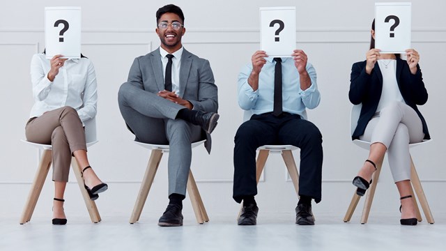 Man at hiring company smile for interview, with manager or boss to join team of workers. Young professional male in group of people, for job recruitment at business or office for growth in career.