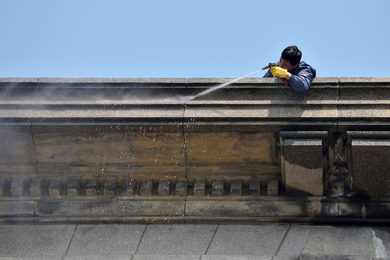 Shanghai, China - March 26: Exterior cleaning and building cleaning with high pressure water jet on March 26, 2016 in Shanghai, China. Shanghai is the largest Chinese city by population.