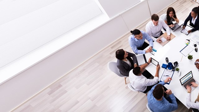 Group Of Multi Ethnic Business Team Sitting Together At Workplace In Modern Office