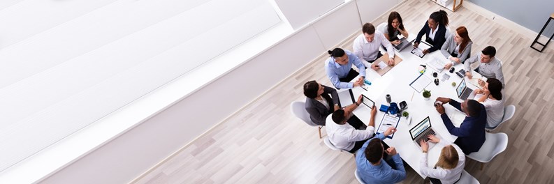 Group Of Multi Ethnic Business Team Sitting Together At Workplace In Modern Office