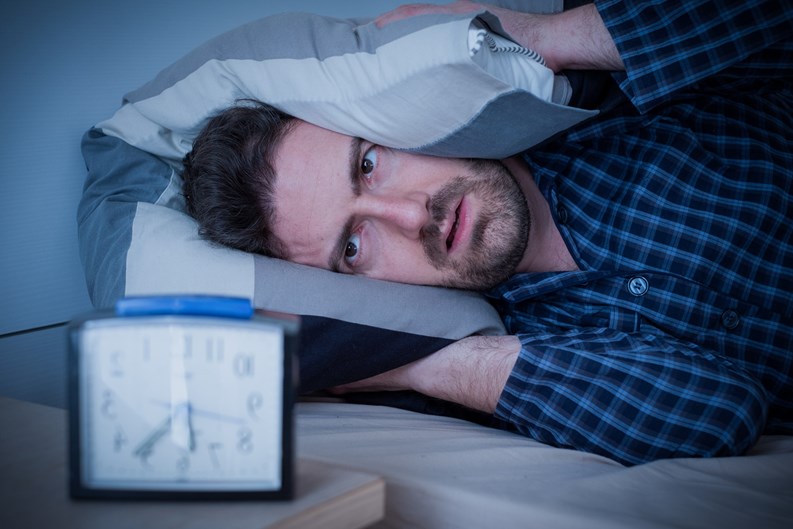 Man feeling tired in the morning after a bed sleep