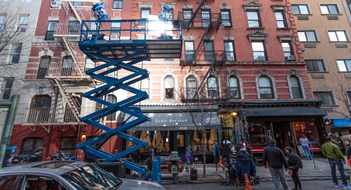 Licensing Your Building for TV & Movie Shoots New York City, United States - March 3, 2016: Cinema lights illuminate a film set on a small street near Chinatown