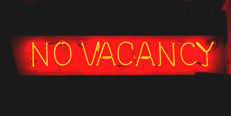 Red neon sign of "No Vacancy" at night