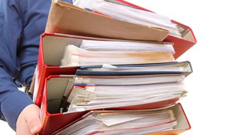 Board Packages & Interviews Man holding stack of folders. Pile with old documents and bills. Isolated on white background
