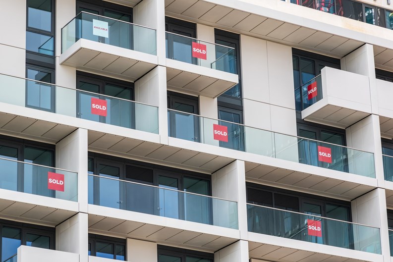 Brand new empty apartments with sold and available signs around Finsbury Park in London