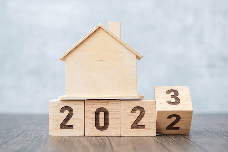 flip 2022 to 2023 block with house model. real estate, Home loan, tax, investment, financial, savings and New Year Resolution concepts