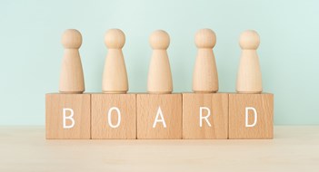 Holding Elections BOARD; Wooden blocks with "BOARD" text of concept and human toys.