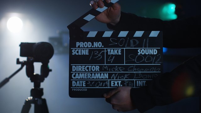 Medium shot of production crew cueing the team to start camera roll