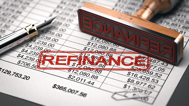 3D illustration of a rubber stamp with the word refinance over a mortgage lender rate sheet. Debt consolidation and debt or loan refinancing concept.