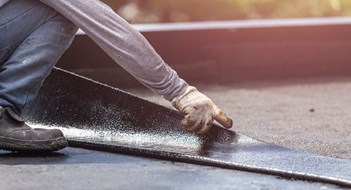 Roof Replacement 101 Asia worker installing tar foil on the rooftop of building. Waterproof system by gas and fire torching
