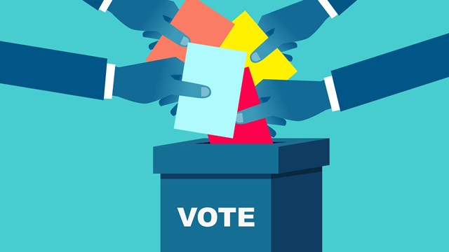 Voting, hand holding the ballot paper into the ballot box