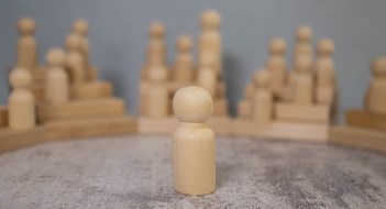 D&O 101 Wooden business team with one person standing out from the crowd concept for leadership or individuality