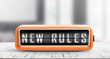 Amending Bylaws and House Rules New rules alarm message on a wooden desk in a bright indoor environment
