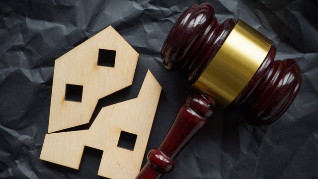 Divided house and wooden gavel. Division of real estate in case of divorce or inheritance.