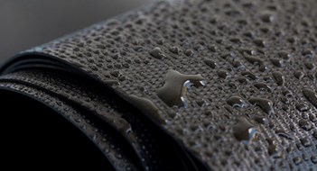 The Slush is Coming Water droplets on the rubber membrane. Waterproofing... Close-up selective focus area.