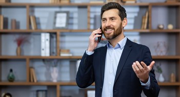 The President’s Role Mature successful boss happy with achievement talking on phone inside office, senior lawyer consulting clients on phone, businessman wearing glasses in business suit, man at workplace standing.