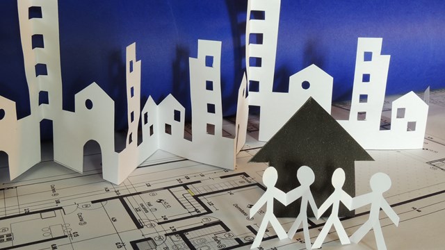real estate concept made of cutted paper over a printed project