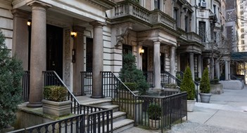 Boosting Curb Appeal on a Budget A row of old brick and stone residential building entrances along a sidewalk on the Upper East Side of New York City