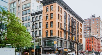 Residential vs Commercial Condo Owners New York City Street View of Residential Buildings and Passing Cars