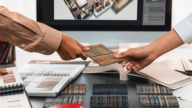 Group of interior architect designer team at table choosing various mood board samples with architecture software on laptop screen. Modern renovation and interior material selection concept. Insight