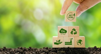 Local Laws & Energy Conservation Net Zero and Carbon Neutral Concepts Net Zero Emissions Goals A climate-neutral long-term strategy Ready to put wooden blocks by hand with green net center icon and green icon on gray background.