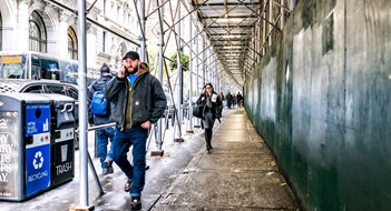 Upper East Side Condo Handed a Win New York City, USA People walking under cover scaffold construction in NYC Manhattan